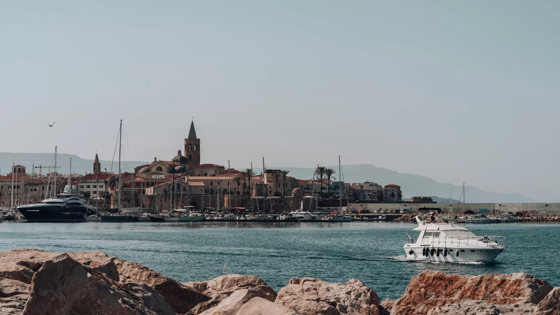 Alghero old town and harbour seen from the sea, Sardinia