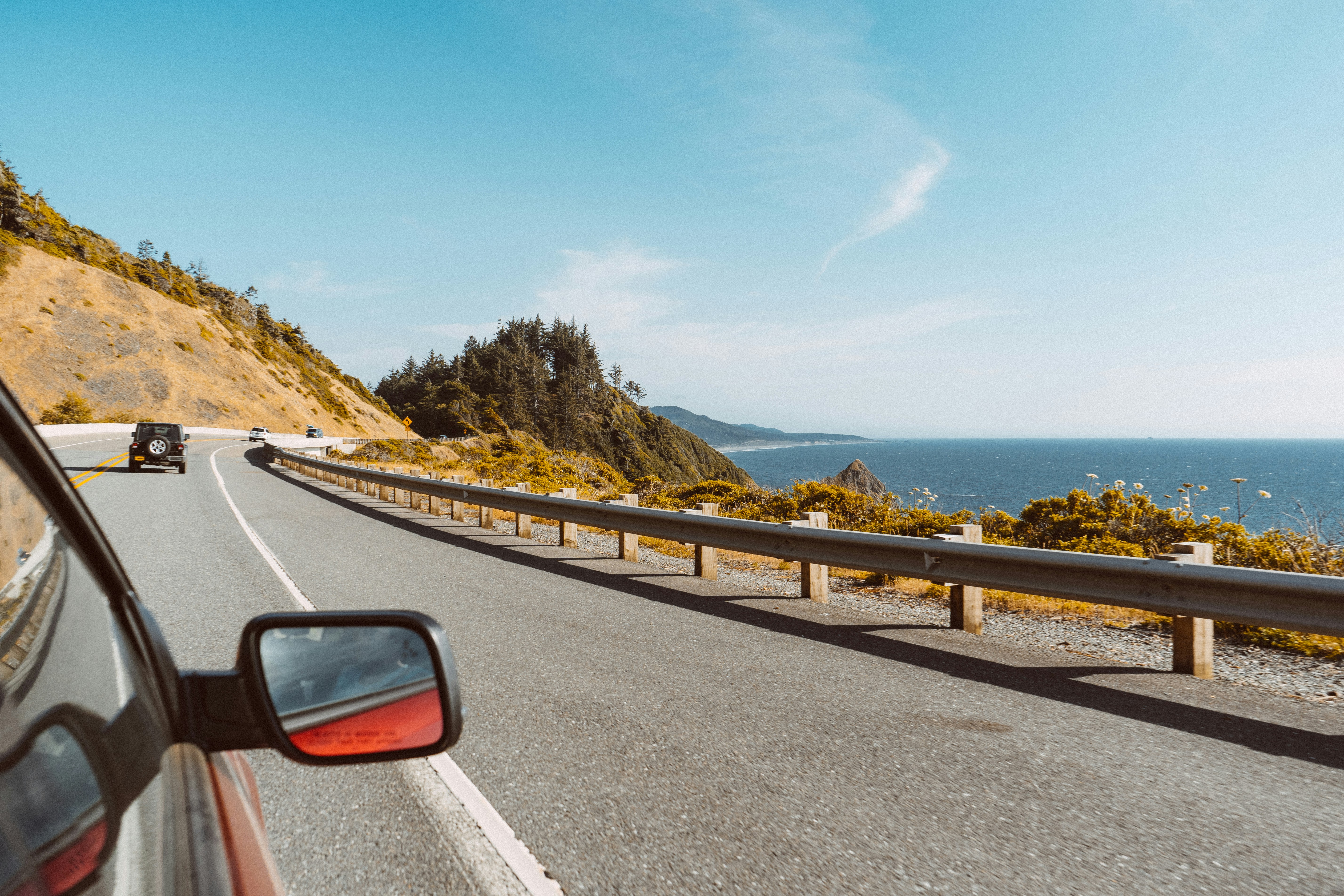 Car on a winding coastal road in Sicily after a car rental at Catania Airport