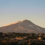 Snow-covered Mount Etna towering over Catania, Sicily
