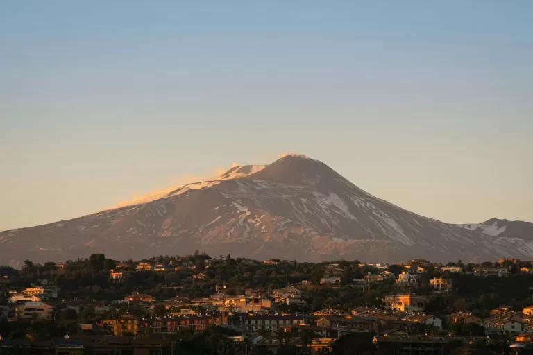 Snow-covered Mount Etna towering over Catania, Sicily
