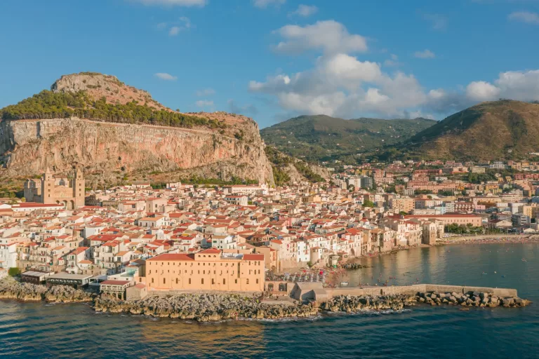 Cefalu old town rising from the sea, a classic day trip after car rental at Palermo Airport