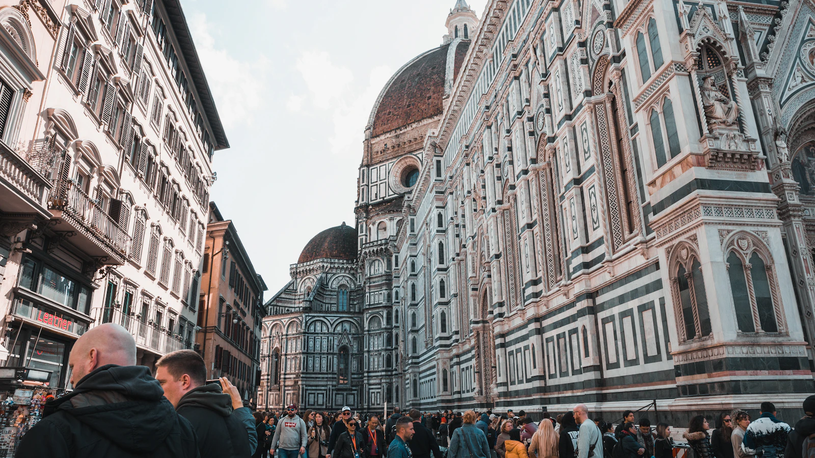 Pedestrians in a street next to Florence Cathedral, inside the city limited traffic zone (ZTL)