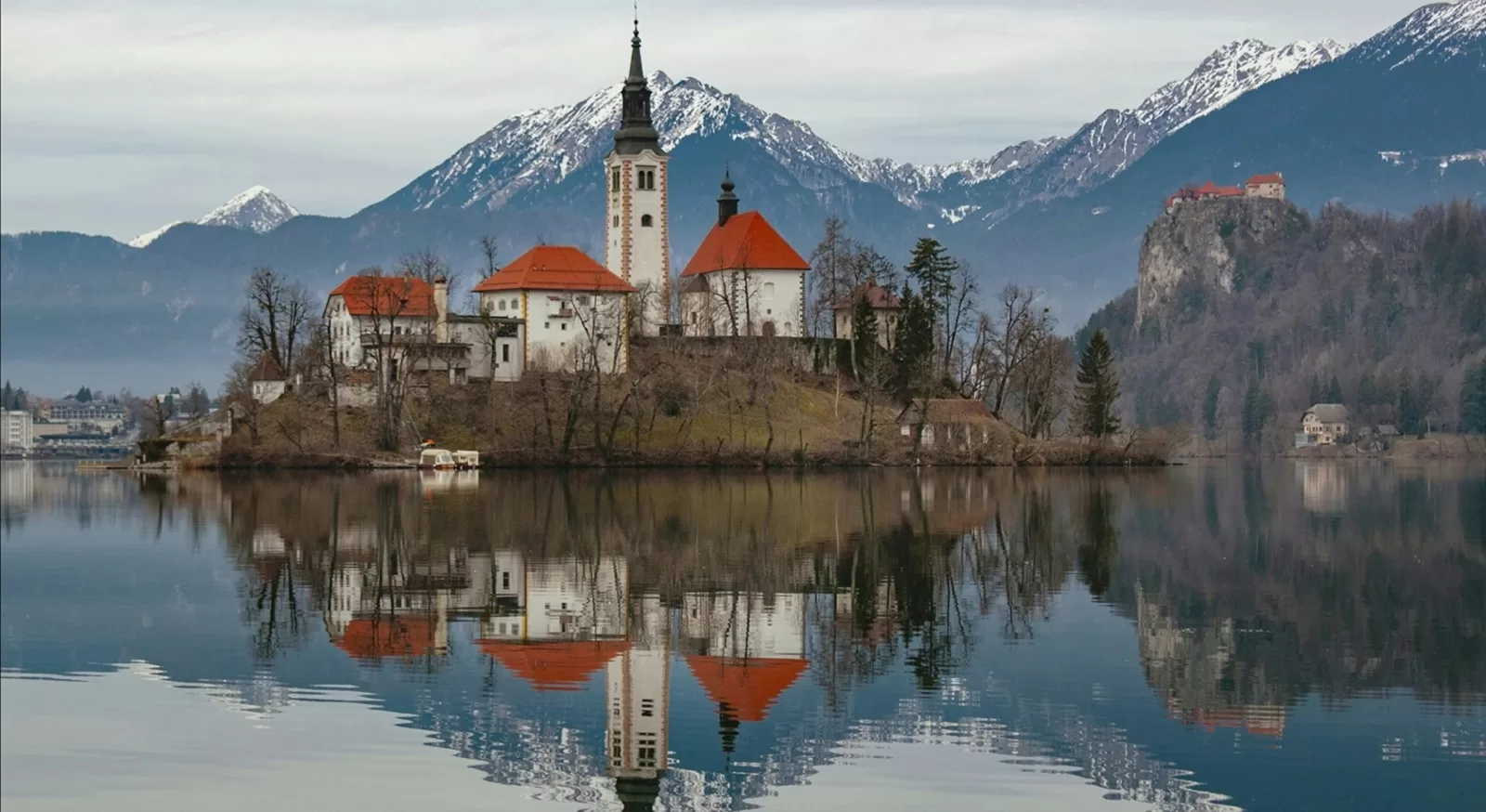 Lake Bled in Slovenia with its island church and Bled Castle below the Julian Alps, about 1 hour 42 minutes by car from Trieste Airport