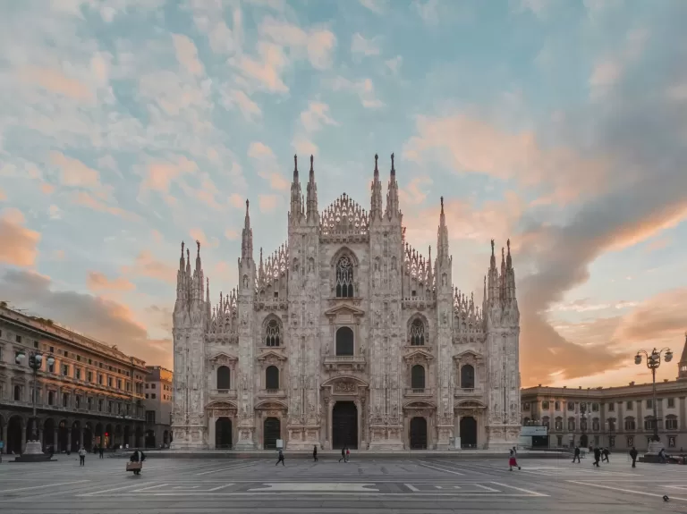 Milan Cathedral on Piazza del Duomo at sunrise, about 18 minutes by car from Milan Linate Airport in light evening traffic