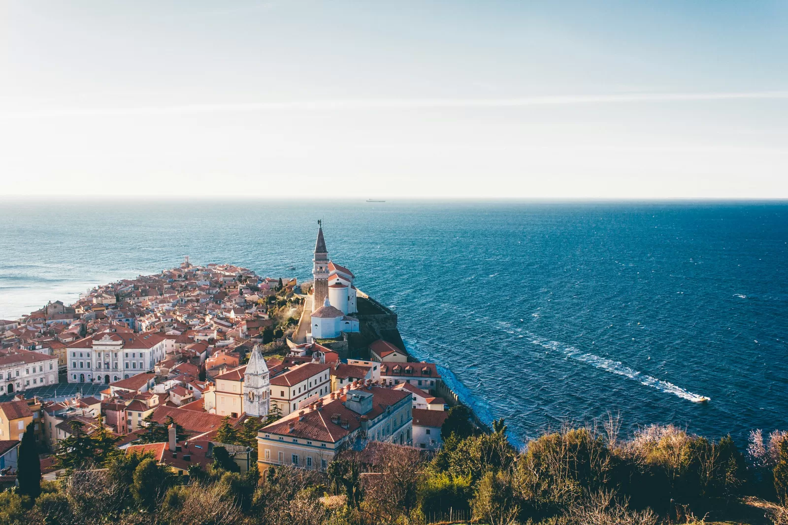 Piran old town on its peninsula in Slovenia, with St George's bell tower above the Adriatic, about 1 hour 3 minutes by car from Trieste Airport