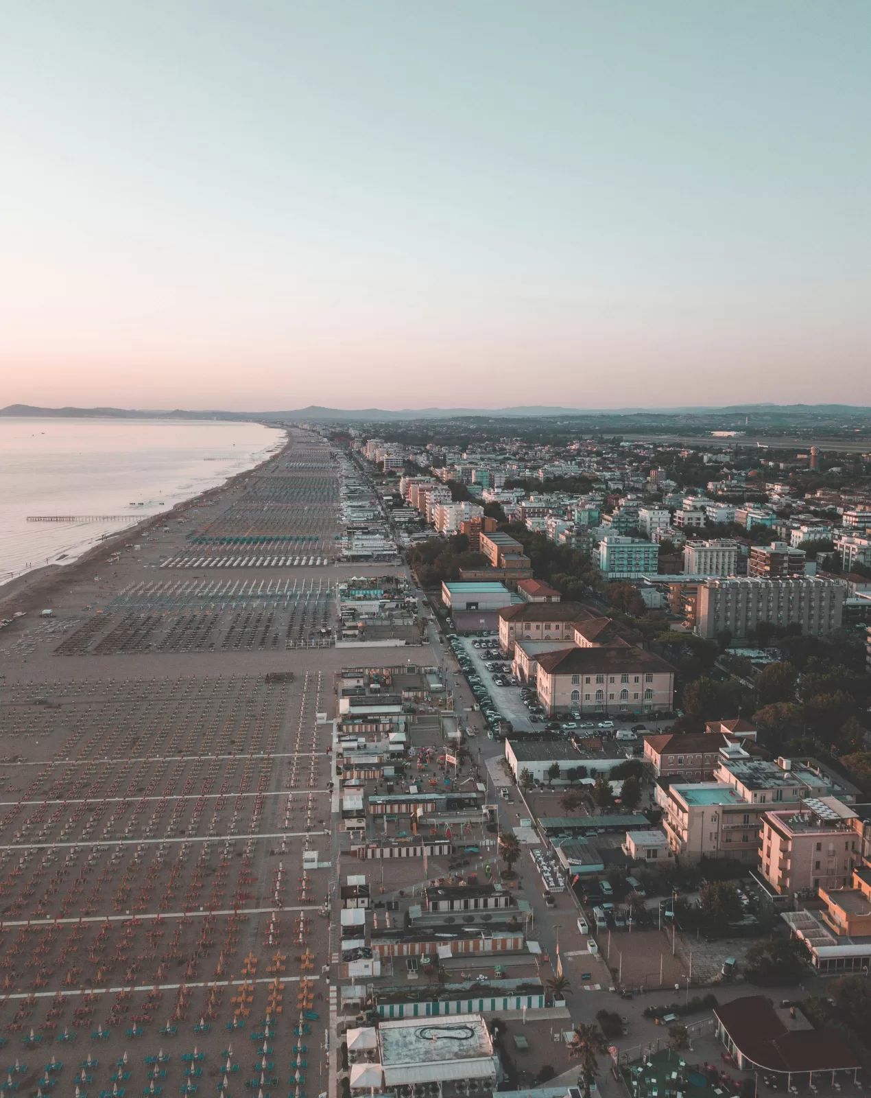 Aerial view of the beach umbrellas and seafront hotels of the Rimini Riviera