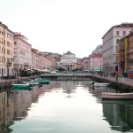 Boats on the Canal Grande in Trieste with the church of Sant'Antonio Taumaturgo at the end, about 34 minutes by car from Trieste Airport