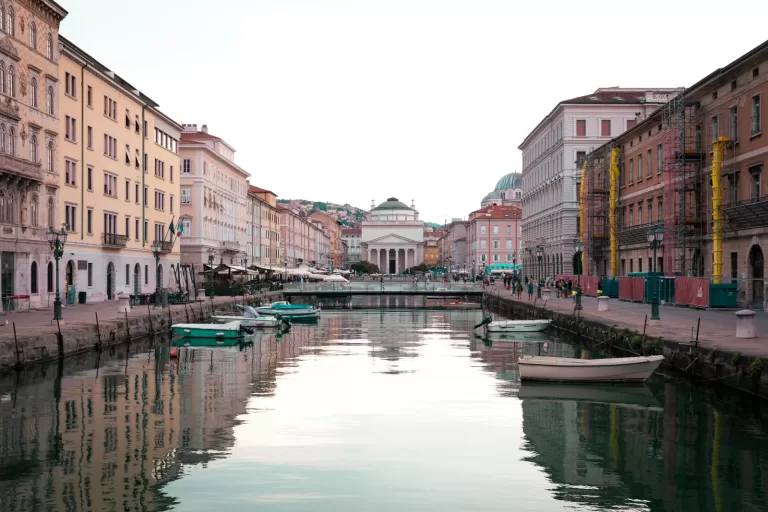 Boats on the Canal Grande in Trieste with the church of Sant'Antonio Taumaturgo at the end, about 34 minutes by car from Trieste Airport