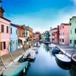 Colourful houses along a canal in the Venice lagoon, where cars cannot go; Piazzale Roma is about 19 minutes by car from Venice Marco Polo Airport