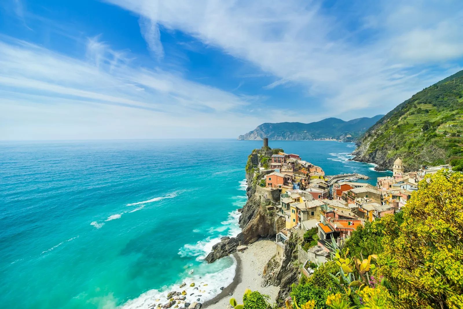 Vernazza in the Cinque Terre on its rocky point; Levanto, where you park for the train, is about 1 hour 16 minutes by car from Genoa Airport